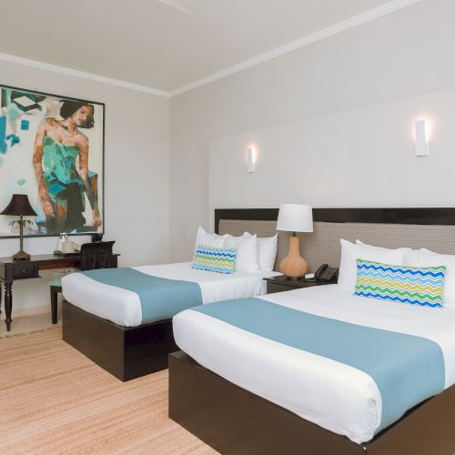 Cozy hotel-style bedroom with two single beds, a shared bedside table, a wall-mounted TV, and modern decor.