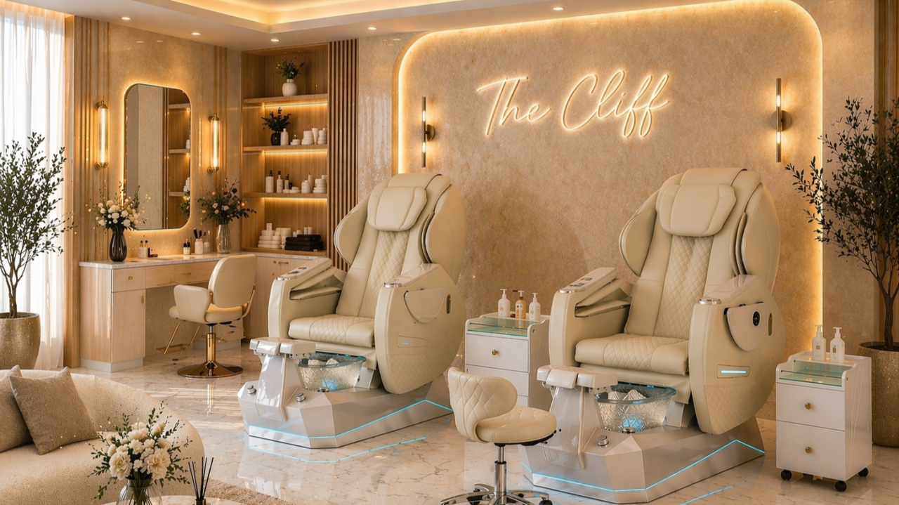 A luxe beauty spa with cream pedicure chairs, soft lighting, marble floors, and a glowing sign &ldquo;The Cliff&rdquo; for a serene pampering experience.